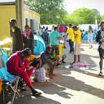 People gathered near tents in an outdoor area