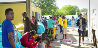 People gathered near tents in an outdoor area