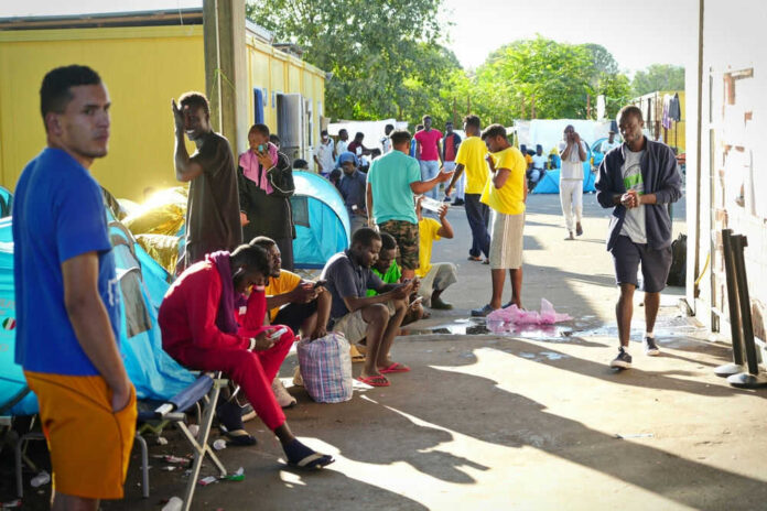 2367903585 People gathered near tents in an outdoor area
