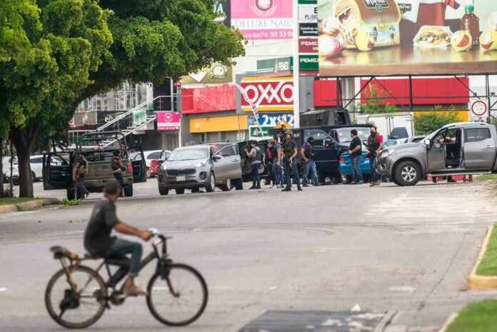 2407259983 Group of people near vehicles on city street