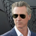 Man wearing sunglasses with a serious expression