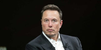 Man in suit sitting with serious expression