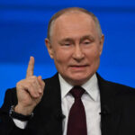 Putin CAVES After Midnight Kremlin Showdown Man in suit gestures with raised index finger